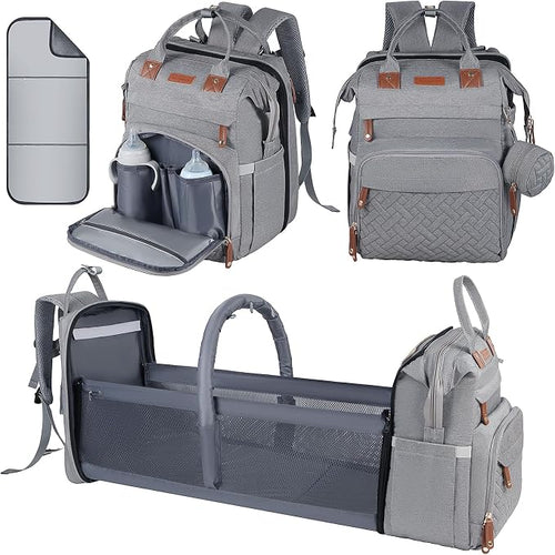 A gray diaper bag backpack shown in multiple configurations on a white background: closed from the front, with the front pocket opened to show interior pockets, and transformed into a bassinet or changing pad with side storage. A small inset at top left shows a matching gray cover or liner.